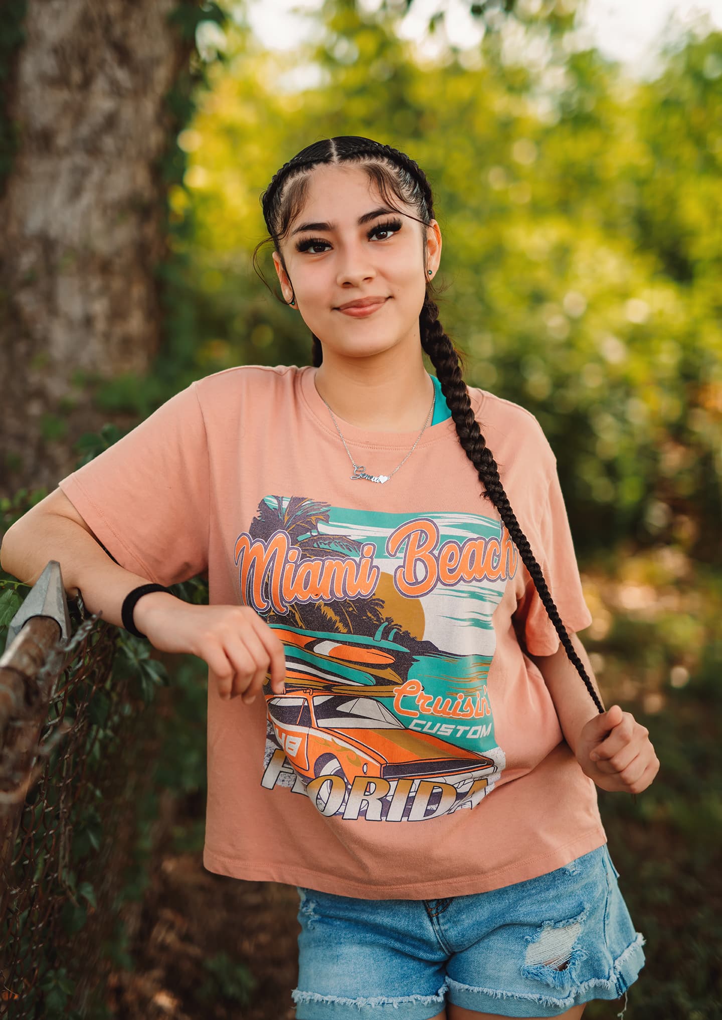 Young woman with braided hair smiling outdoors